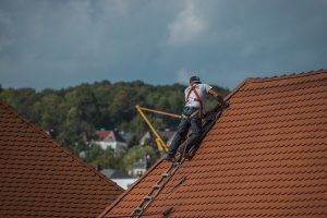 JP Roofing roof installation by worker on a roof