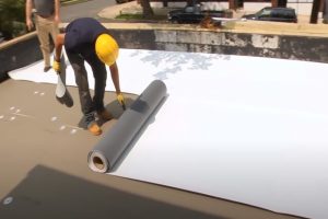 Kitchener Roofing workers flat roof on a commercial property