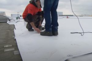 Flat Roof installation by JP Roofing workers