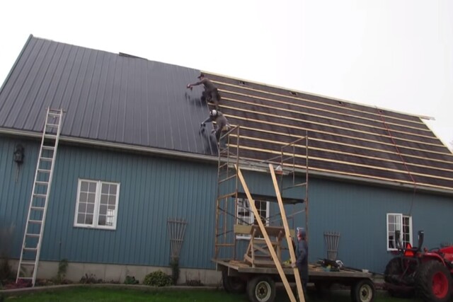 KItchener Roofing workers installing new metal roof.